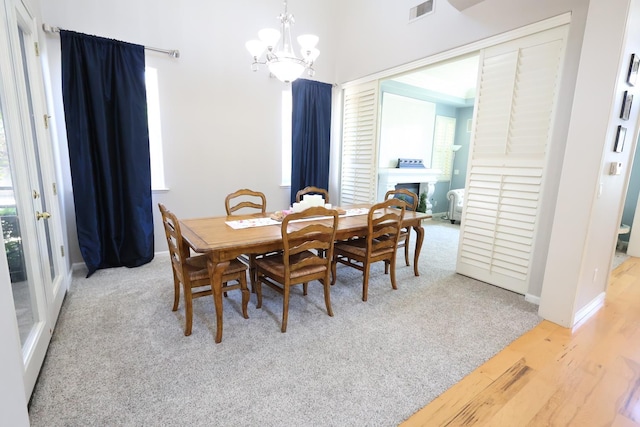 2143 Everglade Ave, Clovis, CA 93619 - dining room featuring a chandelier, healthy amount of natural light, carpet, and baseboards