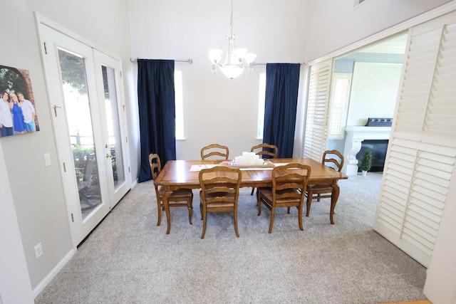 2143 Everglade Ave, Clovis, CA 93619 - carpeted dining space with a chandelier and a glass covered fireplace