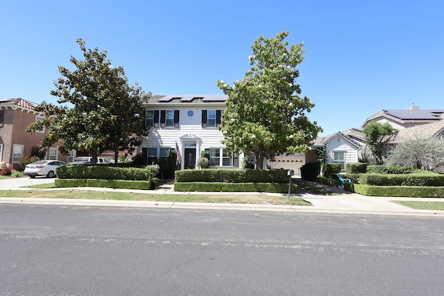 2143 Everglade Ave, Clovis, CA 93619 - view of front of home with roof mounted solar panels, a garage, and concrete driveway