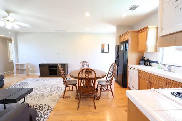 2143 Everglade Ave, Clovis, CA 93619 - kitchen featuring black refrigerator with ice dispenser, white dishwasher, tile counters, open floor plan, and recessed lighting