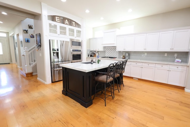 2143 Everglade Ave, Clovis, CA 93619 - kitchen with stainless steel appliances, backsplash, light wood finished floors, light countertops, and recessed lighting