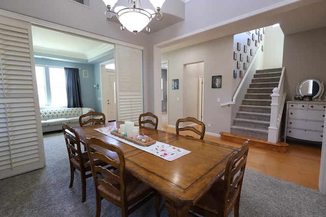 2143 Everglade Ave, Clovis, CA 93619 - dining area featuring carpet, a chandelier, stairway, and crown molding