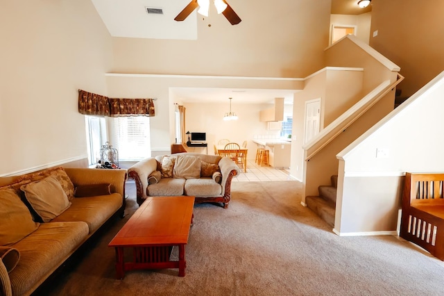 1866 E Goshen Ave, Fresno, CA 93720 - living room featuring a towering ceiling, a ceiling fan, carpet flooring, and stairs