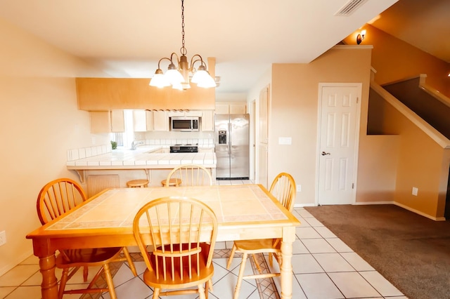 1866 E Goshen Ave, Fresno, CA 93720 - dining space with a chandelier, light colored carpet, baseboards, and light tile patterned floors
