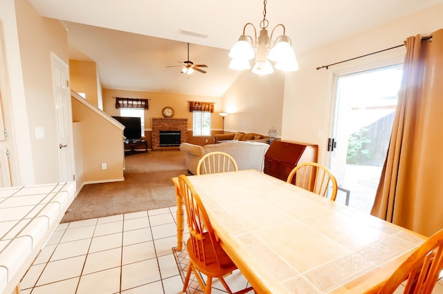 1866 E Goshen Ave, Fresno, CA 93720 - dining area with light colored carpet, a brick fireplace, light tile patterned floors, ceiling fan, and a chandelier
