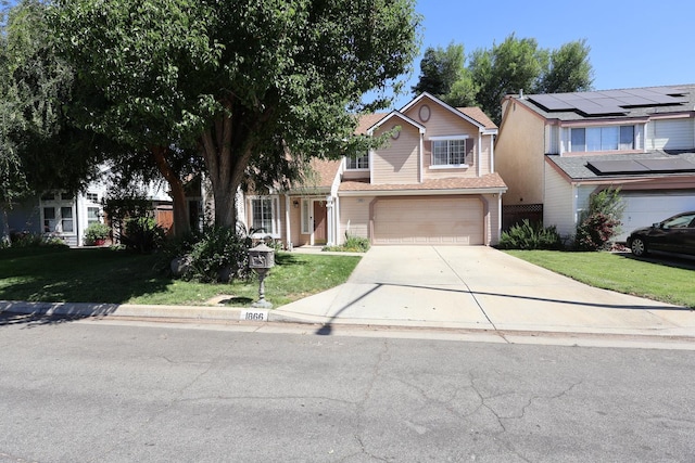 1866 E Goshen Ave, Fresno, CA 93720 - view of front of house featuring concrete driveway, a front lawn, and a garage