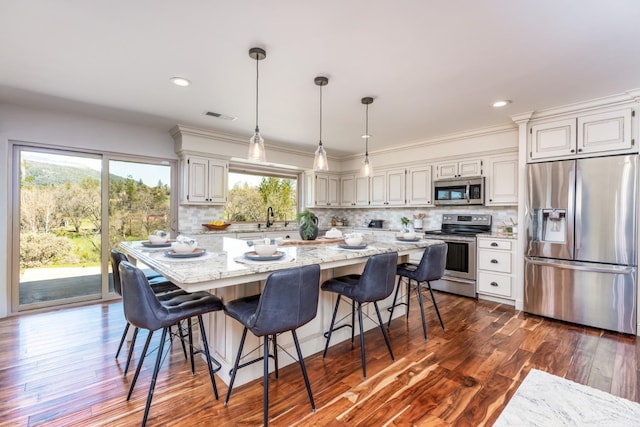 55606 Rd 226, North Fork, CA 93643 - kitchen with appliances with stainless steel finishes, light stone countertops, decorative backsplash, hanging light fixtures, and recessed lighting