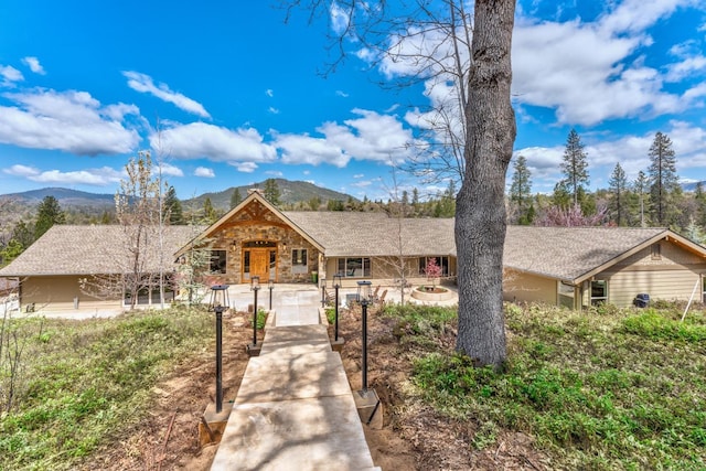 55606 Rd 226, North Fork, CA 93643 - view of front facade with a mountain view, stone siding, and covered porch