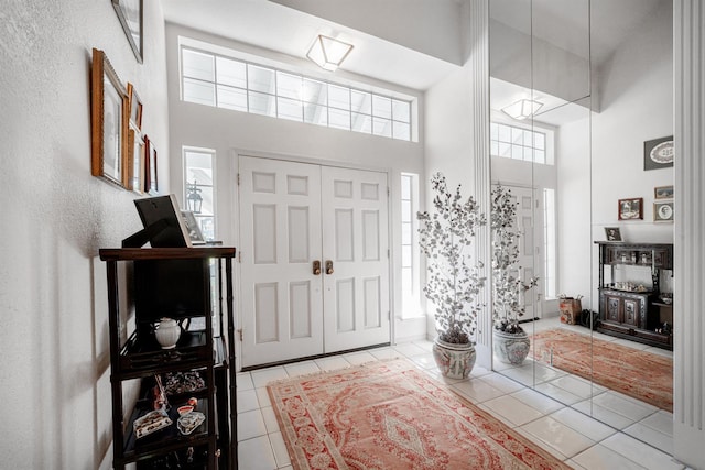 9109 N Chadwick Ln, Fresno, CA 93720 - tiled entryway featuring a towering ceiling and a textured wall