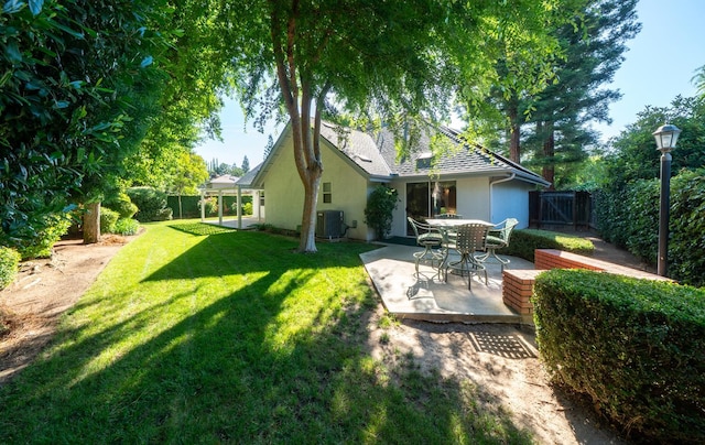 9109 N Chadwick Ln, Fresno, CA 93720 - back of property featuring stucco siding, a patio, and central air condition unit