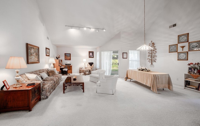 9109 N Chadwick Ln, Fresno, CA 93720 - living area featuring track lighting, high vaulted ceiling, and carpet flooring
