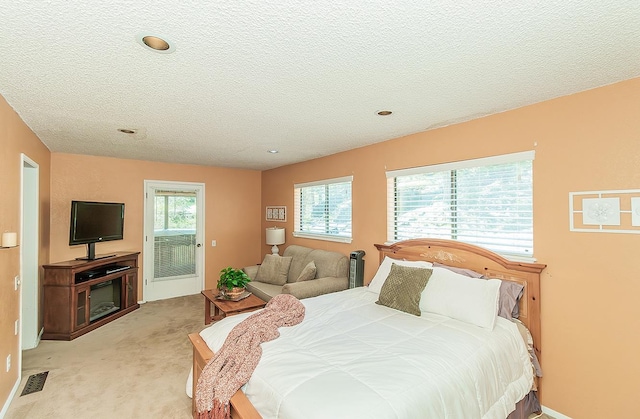 38830 Littlefield Rd, Shaver Lake, CA 93664 - bedroom with light carpet, a textured ceiling, and access to exterior