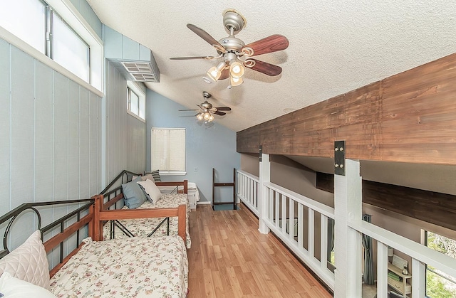 38830 Littlefield Rd, Shaver Lake, CA 93664 - bedroom featuring a textured ceiling, light wood-style floors, and lofted ceiling