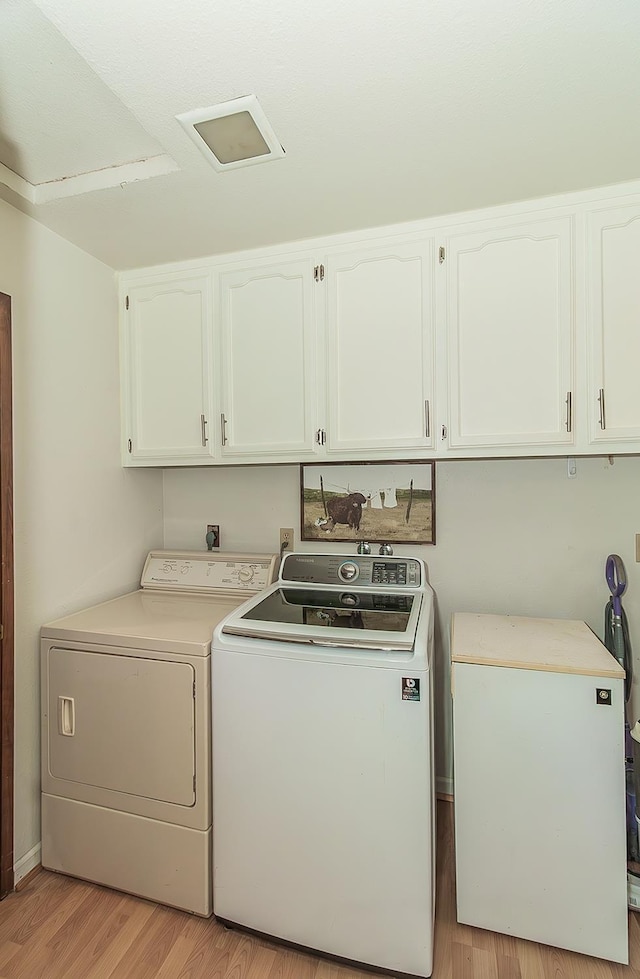 38830 Littlefield Rd, Shaver Lake, CA 93664 - laundry room with cabinet space, washer and dryer, and light wood finished floors
