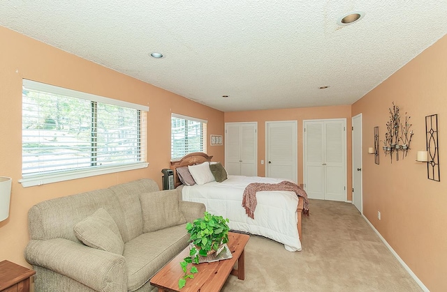 38830 Littlefield Rd, Shaver Lake, CA 93664 - bedroom featuring light carpet, multiple closets, a textured ceiling, recessed lighting, and baseboards