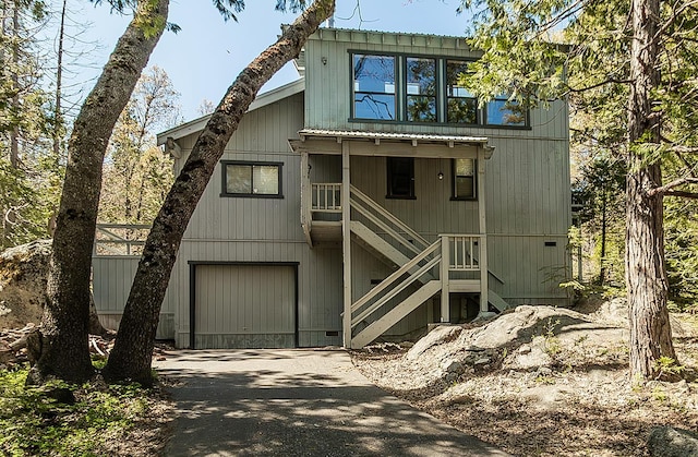 38830 Littlefield Rd, Shaver Lake, CA 93664 - chalet / cabin featuring driveway, stairs, and an attached garage