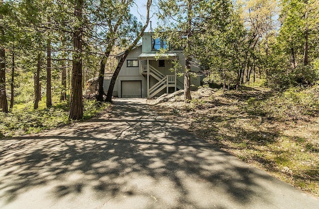 38830 Littlefield Rd, Shaver Lake, CA 93664 - view of front of property with asphalt driveway, stairs, and an attached garage