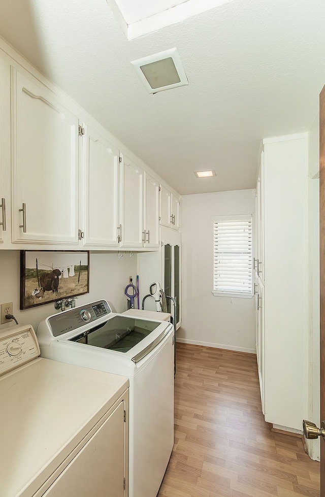 38830 Littlefield Rd, Shaver Lake, CA 93664 - laundry area with cabinet space, washer and dryer, light wood-style flooring, and baseboards