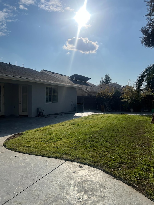 5138 W Beechwood Ave, Fresno, CA 93722 - back of house with a patio, a lawn, and stucco siding