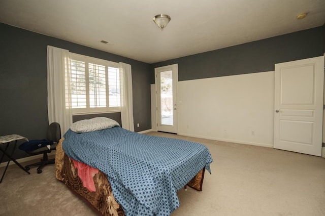 5138 W Beechwood Ave, Fresno, CA 93722 - bedroom with baseboards, light colored carpet, and access to outside