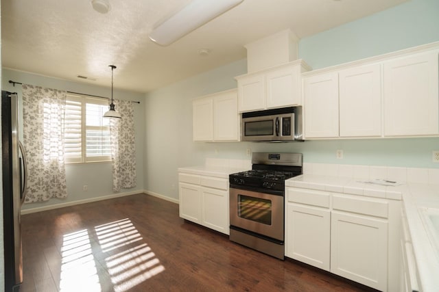 5138 W Beechwood Ave, Fresno, CA 93722 - kitchen featuring stainless steel appliances, tile counters, white cabinets, and dark wood-type flooring