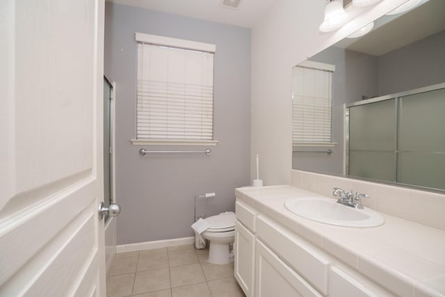 5138 W Beechwood Ave, Fresno, CA 93722 - full bath featuring toilet, vanity, tile patterned floors, an enclosed shower, and baseboards