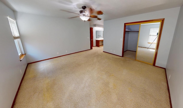 1604 W Central Ave, Madera, CA 93637 - unfurnished bedroom with multiple windows, carpet, a closet, and ceiling fan