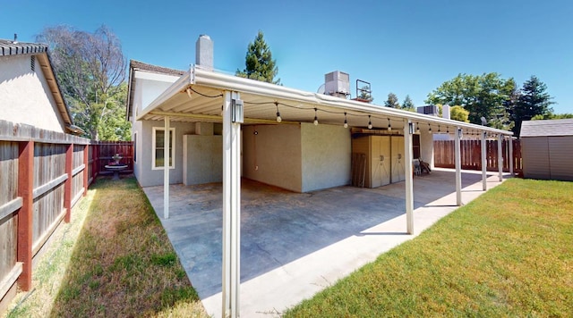 1604 W Central Ave, Madera, CA 93637 - rear view of property featuring stucco siding, a chimney, a fenced backyard, and a patio area