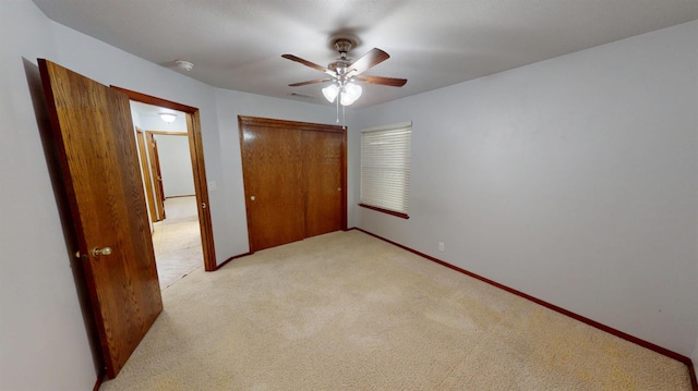 1604 W Central Ave, Madera, CA 93637 - unfurnished bedroom featuring a closet, light colored carpet, and a ceiling fan