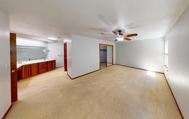 1604 W Central Ave, Madera, CA 93637 - unfurnished bedroom with a closet, baseboards, light colored carpet, and a ceiling fan