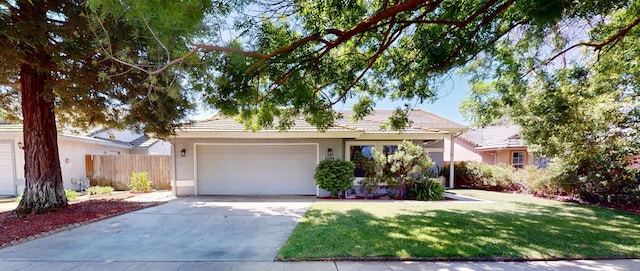 1604 W Central Ave, Madera, CA 93637 - ranch-style house with an attached garage, stucco siding, driveway, and a tiled roof