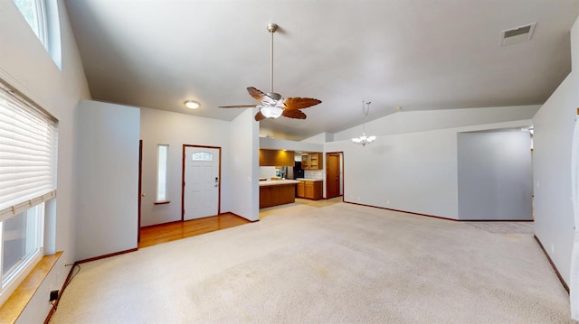 1604 W Central Ave, Madera, CA 93637 - unfurnished living room featuring lofted ceiling, light colored carpet, ceiling fan, a chandelier, and baseboards