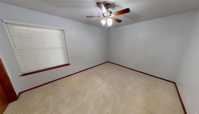 1604 W Central Ave, Madera, CA 93637 - empty room featuring light colored carpet, ceiling fan, and baseboards
