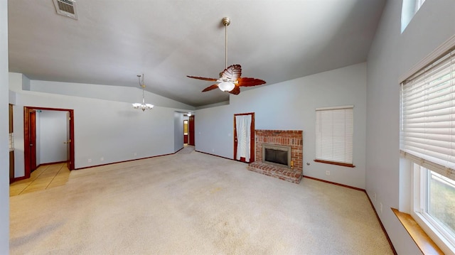 1604 W Central Ave, Madera, CA 93637 - unfurnished living room featuring vaulted ceiling, a chandelier, a ceiling fan, a fireplace, and carpet floors