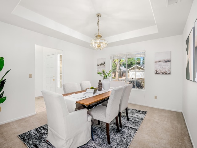 7549 N 8th, Fresno, CA 93720 - dining room featuring a tray ceiling, a chandelier, light colored carpet, and baseboards