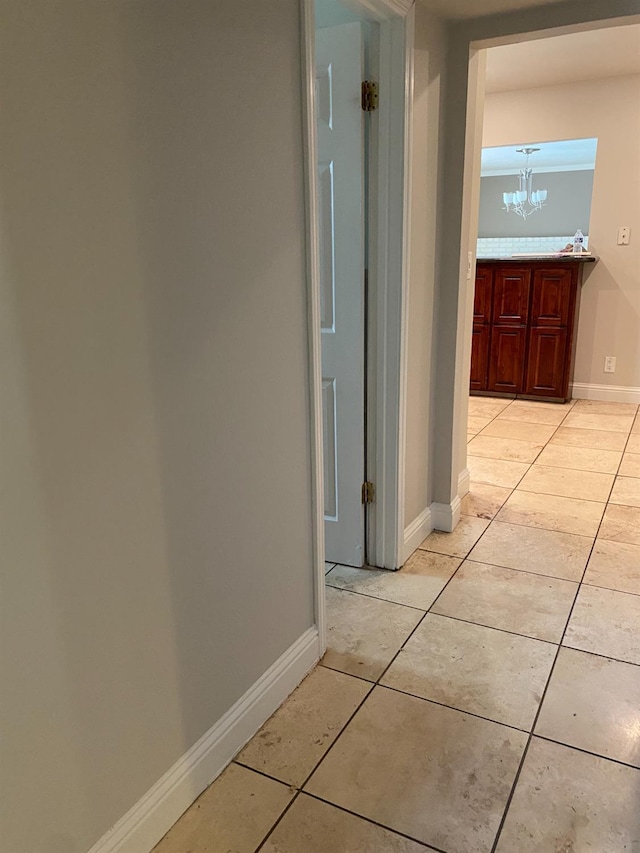 7371 N Highland, Clovis, CA 93619 - hall featuring a chandelier, light tile patterned flooring, and baseboards