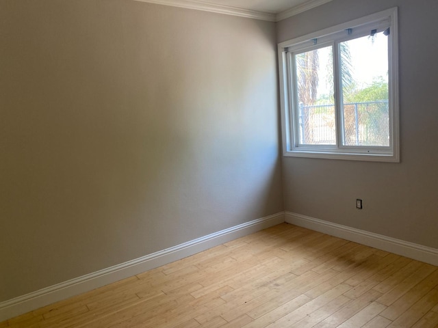 7371 N Highland, Clovis, CA 93619 - unfurnished room featuring baseboards, ornamental molding, and light wood-style floors