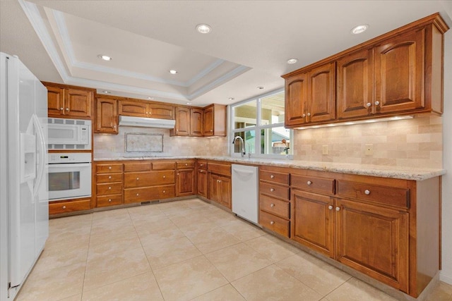 3595 W Magill Ave, Fresno, CA 93711 - kitchen with white appliances, under cabinet range hood, brown cabinets, a raised ceiling, and decorative backsplash