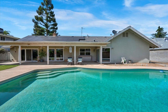 3595 W Magill Ave, Fresno, CA 93711 - back of property with a ceiling fan, solar panels, a patio area, and an outdoor pool
