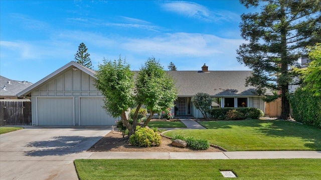 3595 W Magill Ave, Fresno, CA 93711 - view of front of property with concrete driveway, an attached garage, board and batten siding, and a chimney