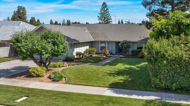 3595 W Magill Ave, Fresno, CA 93711 - view of front of home featuring board and batten siding, a front lawn, and roof with shingles