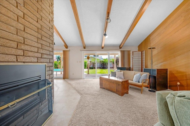 3595 W Magill Ave, Fresno, CA 93711 - living room featuring light tile patterned floors, a glass covered fireplace, and wooden walls