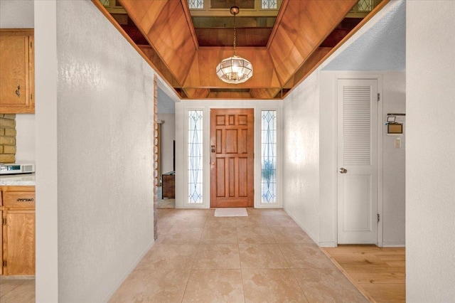 3595 W Magill Ave, Fresno, CA 93711 - foyer featuring a textured wall, a chandelier, baseboards, and light tile patterned floors