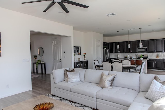 508 Laurel Crest Ave, Madera, CA 93636 - living room featuring ceiling fan, light wood-type flooring, and baseboards