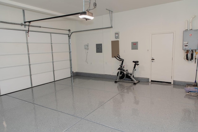 508 Laurel Crest Ave, Madera, CA 93636 - garage with a garage door opener, electric panel, tankless water heater, and baseboards