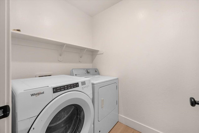 2520 S Spruce St, Visalia, CA 93292 - washroom with washing machine and clothes dryer, light wood finished floors, and baseboards