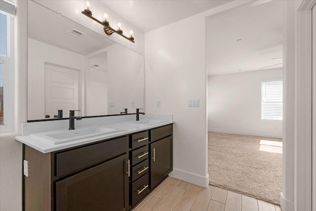 2520 S Spruce St, Visalia, CA 93292 - full bathroom featuring double vanity, wood finished floors, and baseboards