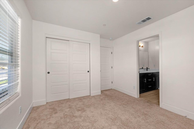 2520 S Spruce St, Visalia, CA 93292 - unfurnished bedroom with light colored carpet, multiple windows, a closet, and baseboards
