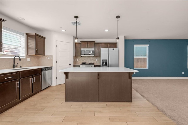 2520 S Spruce St, Visalia, CA 93292 - kitchen featuring appliances with stainless steel finishes, a sink, dark brown cabinets, light countertops, and recessed lighting