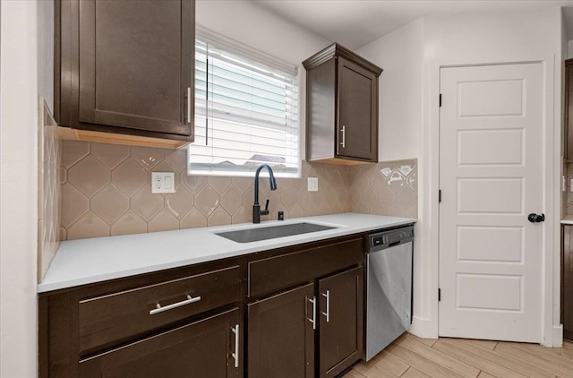 2520 S Spruce St, Visalia, CA 93292 - kitchen featuring stainless steel dishwasher, a sink, dark brown cabinets, light countertops, and light wood-type flooring